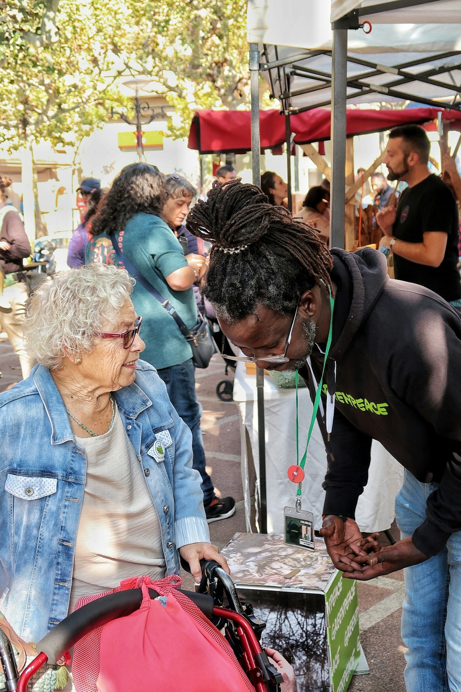Community members and volunteers connecting at a local food and wellness gathering